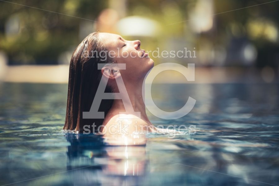 Woman Relaxing In The Pool Water. A Beautiful Woman Floating In Angelo Cordeschi