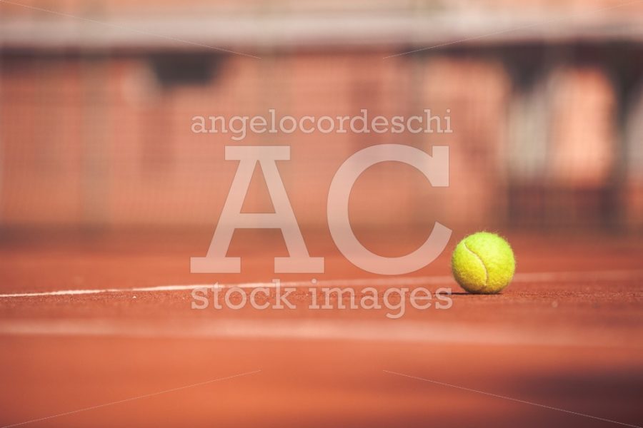 Yellow Tennis Ball On A Clay Court. Playing Tennis Outdoors. The Angelo Cordeschi