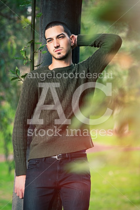Young And Handsome Guy Leaning Against A Tree In Nature Relaxing Angelo Cordeschi