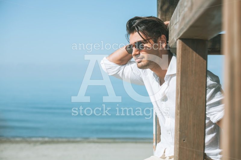 Young Attractive Man With Sunglasses Looking On The Beach Angelo Cordeschi