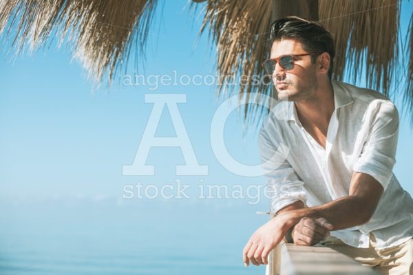 Young Attractive Man With Sunglasses Looking Out Over The Sea Angelo Cordeschi