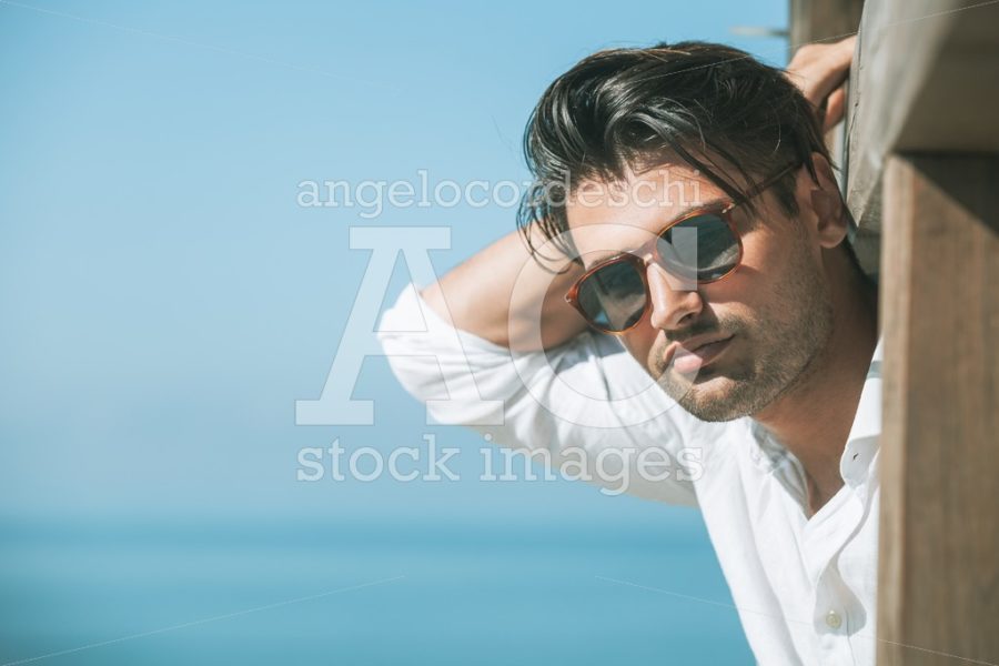 Young Attractive Man With Sunglasses Looking Outdoor On Th Beach Angelo Cordeschi