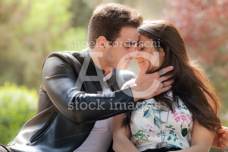 Young Couple Loving Outdoors In A Park. A Young Man And Young Wo Angelo Cordeschi