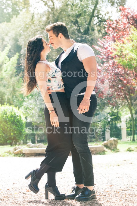 Young Couple Loving Outdoors In A Park. A Young Man And Young Wo Angelo Cordeschi