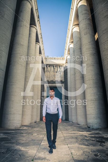 Young Trendy Man Walking Through The Ancient Columns Of A Histor Angelo Cordeschi